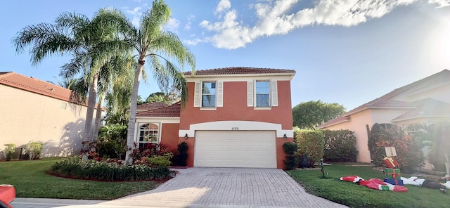 mediterranean / spanish home featuring a front lawn and a garage