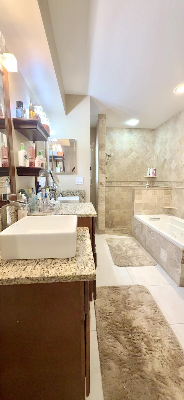 bathroom featuring tile patterned flooring, vanity, and independent shower and bath