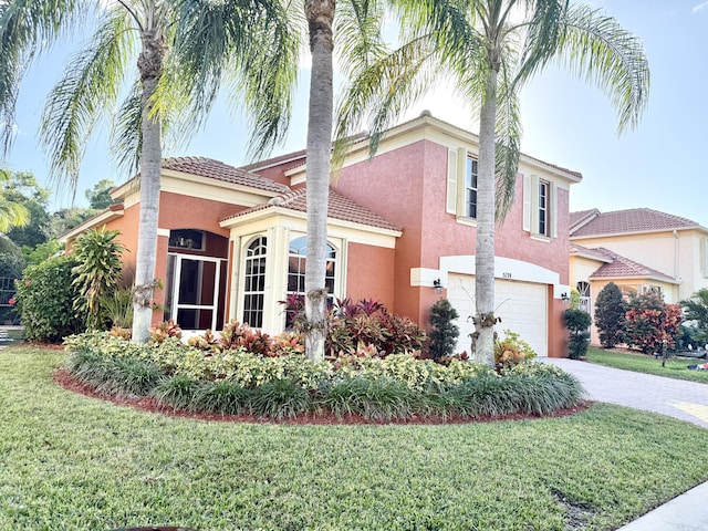 view of front facade with a garage and a front lawn