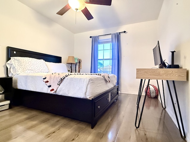 bedroom with light hardwood / wood-style flooring, ceiling fan, and lofted ceiling