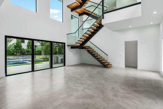 unfurnished living room with a high ceiling