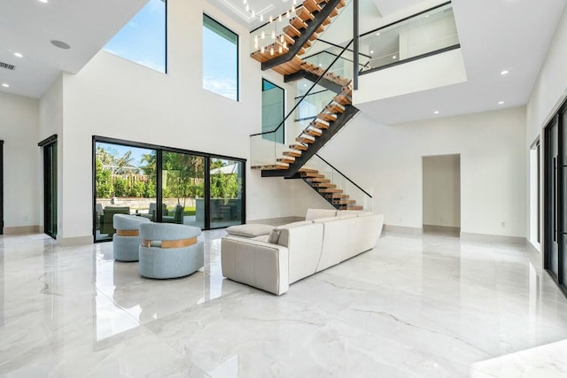 unfurnished living room featuring a towering ceiling