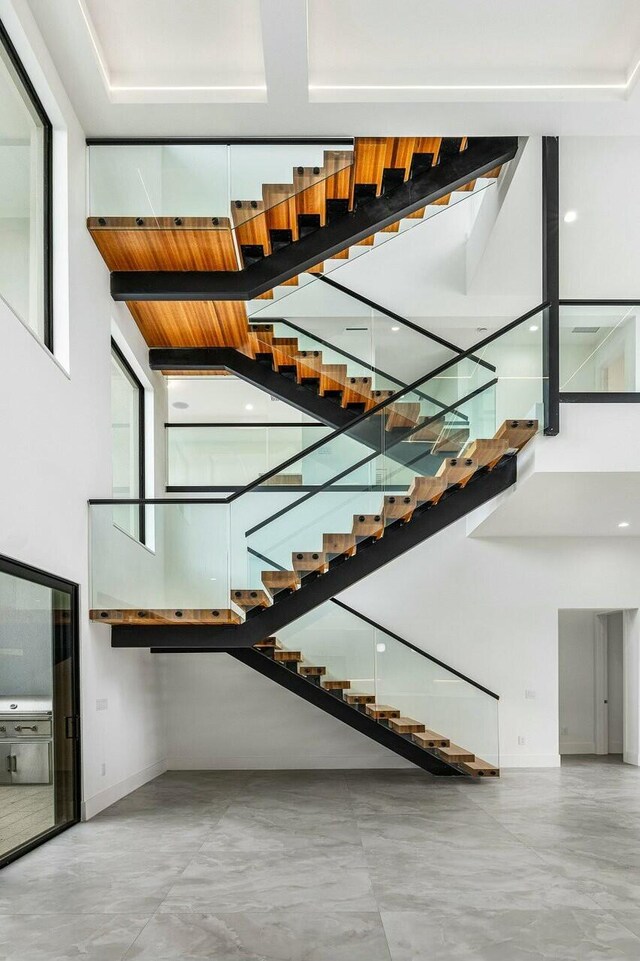 stairs featuring a high ceiling