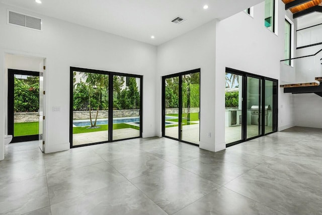 doorway to outside featuring a high ceiling and french doors