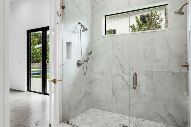 bathroom featuring a shower with shower door