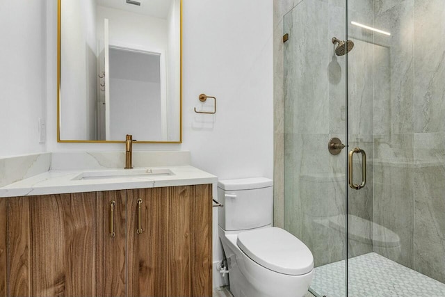 bathroom with an enclosed shower, vanity, and toilet