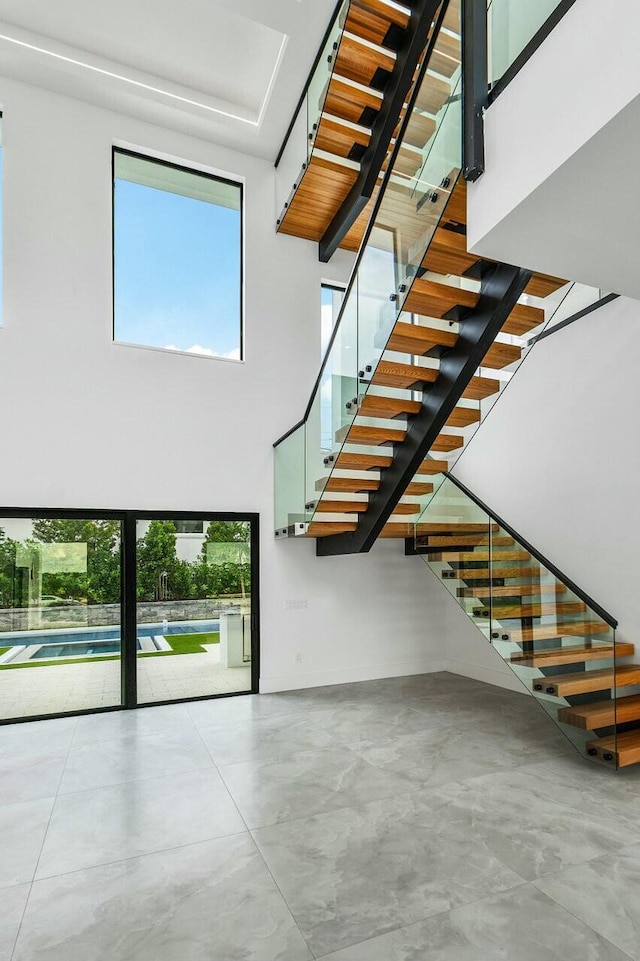 staircase featuring a high ceiling