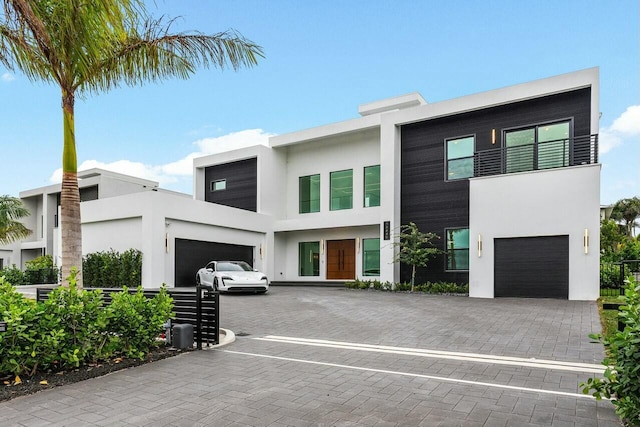 contemporary house featuring a balcony and a garage