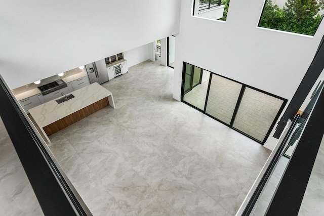 unfurnished living room featuring sink