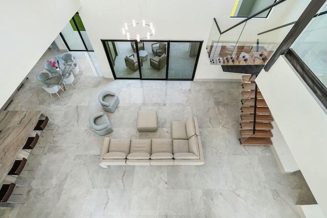 unfurnished living room with an inviting chandelier