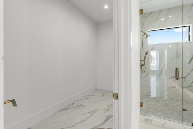 bathroom featuring a shower with shower door