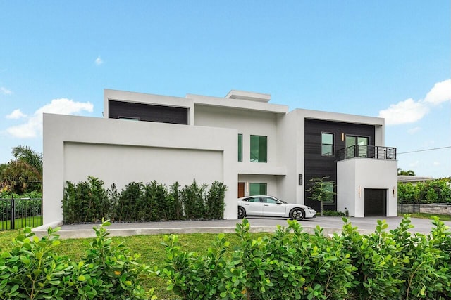 contemporary home featuring a balcony and a garage