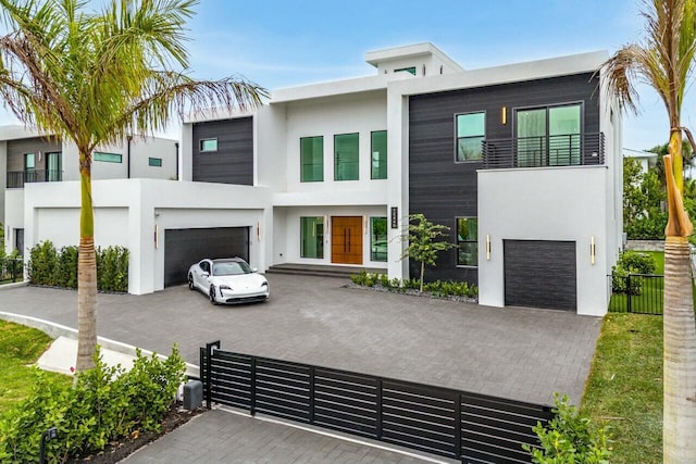 contemporary house with a garage and a balcony