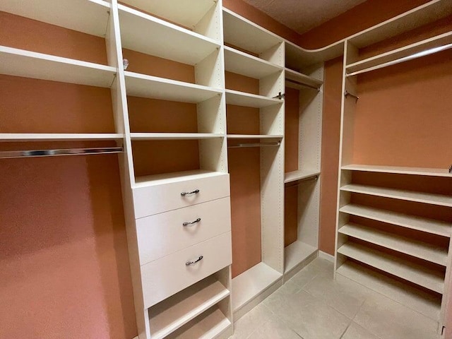 spacious closet featuring tile patterned floors