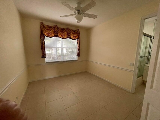 unfurnished room featuring ceiling fan and light tile patterned floors