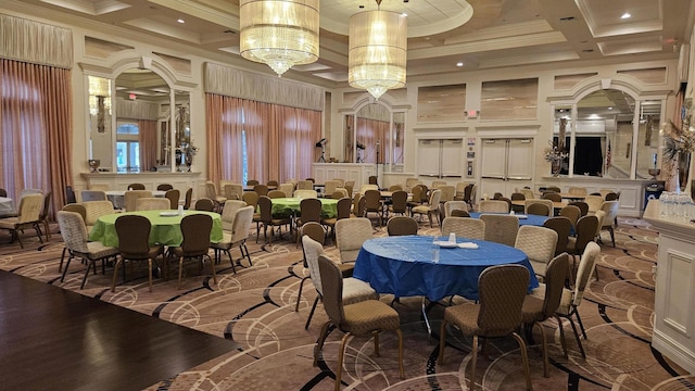 dining area with a high ceiling, ornamental molding, a notable chandelier, and coffered ceiling