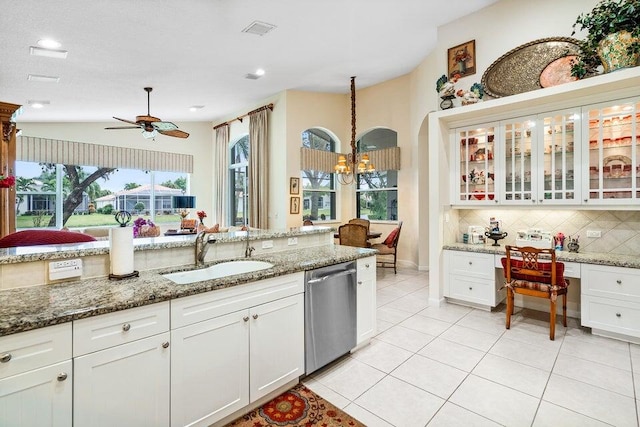 kitchen with white cabinetry, dishwasher, sink, backsplash, and ceiling fan with notable chandelier