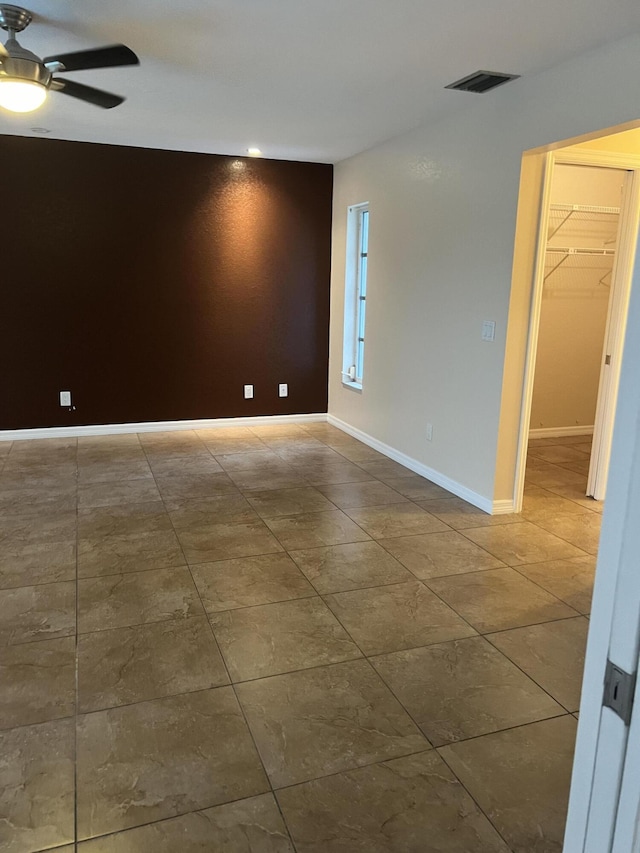 unfurnished room with ceiling fan