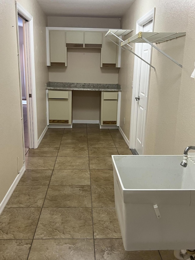 washroom featuring tile patterned flooring and sink