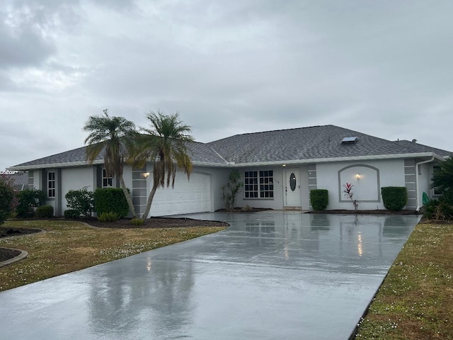 ranch-style house featuring a garage and a front lawn