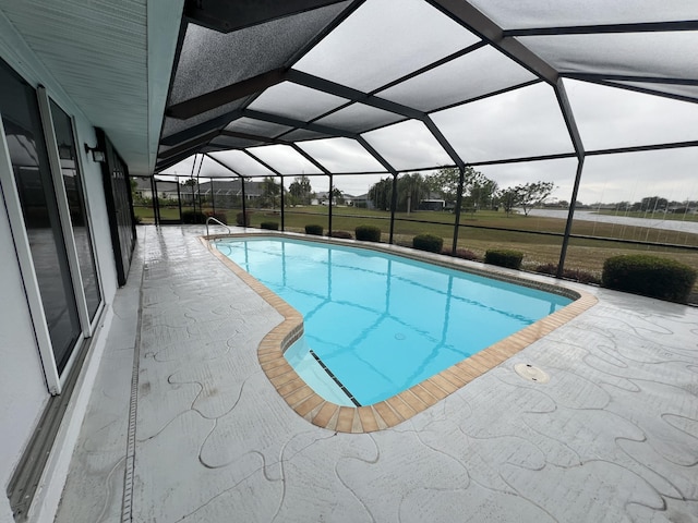 view of swimming pool with glass enclosure and a patio area