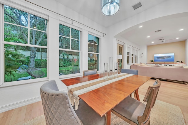 dining room with an inviting chandelier and light hardwood / wood-style flooring