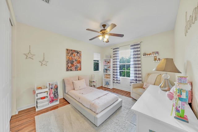 bedroom featuring hardwood / wood-style floors and ceiling fan