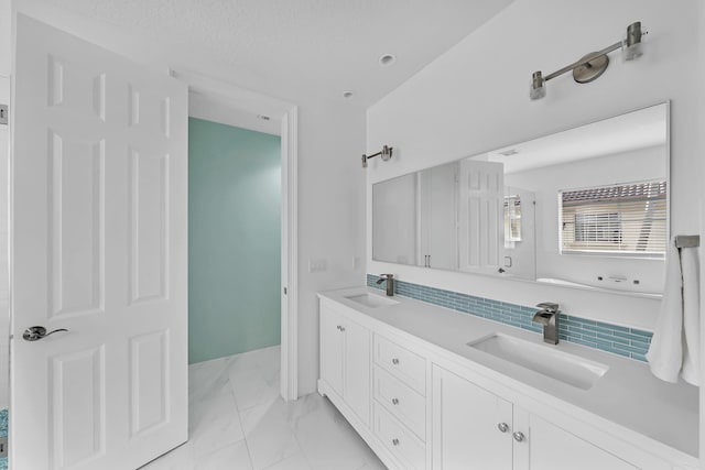 bathroom featuring tasteful backsplash and vanity