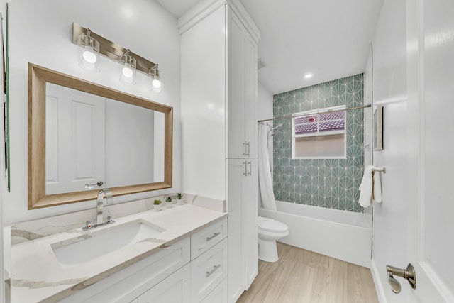 full bathroom with wood-type flooring, vanity, toilet, and shower / bath combo with shower curtain