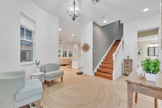 entryway with light wood-type flooring and a notable chandelier