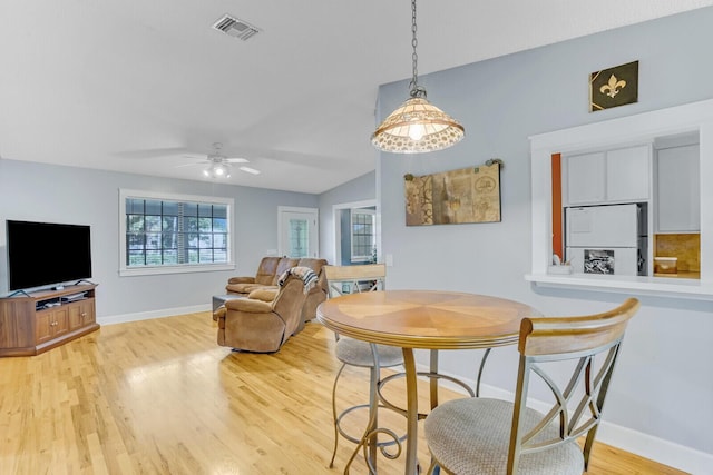 dining area featuring light hardwood / wood-style floors, ceiling fan, and lofted ceiling