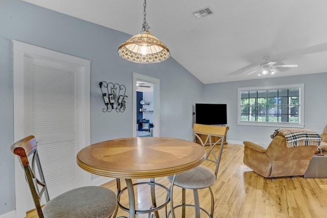 dining area featuring wood-type flooring, ceiling fan, and lofted ceiling