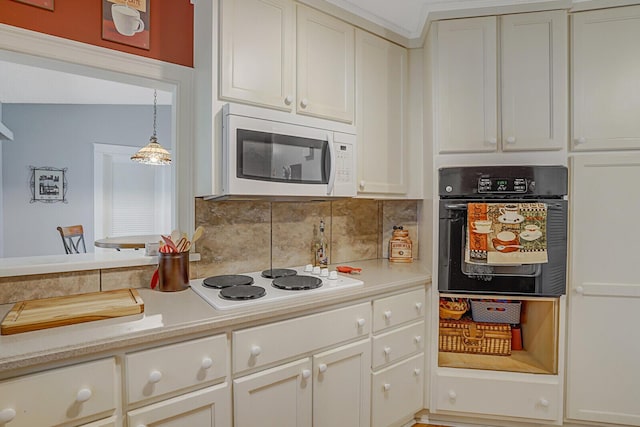 kitchen with tasteful backsplash, decorative light fixtures, and white appliances