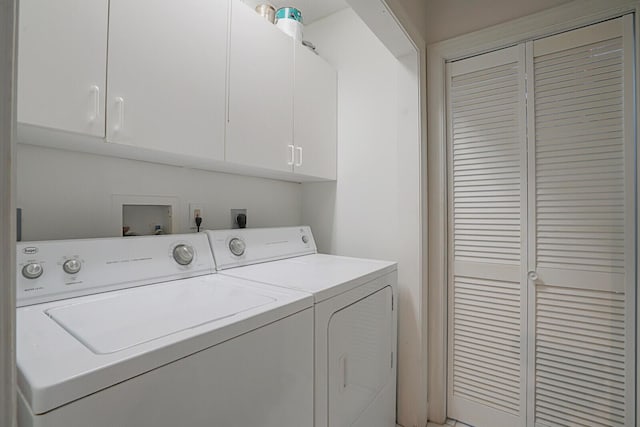 laundry area with cabinets and washing machine and dryer