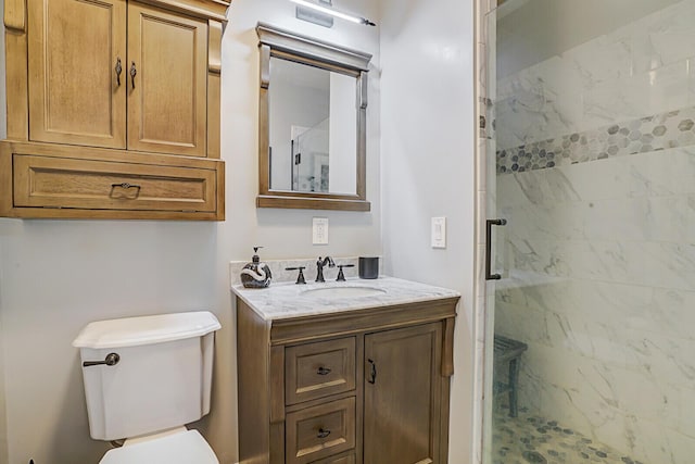 bathroom featuring vanity, toilet, and an enclosed shower