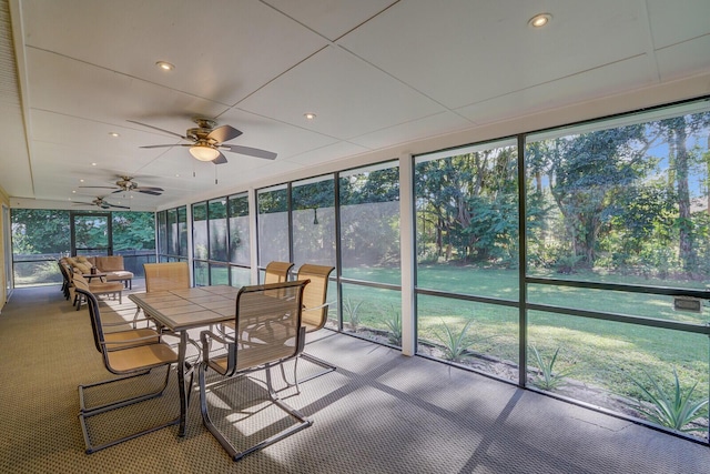 sunroom / solarium featuring ceiling fan and a wealth of natural light