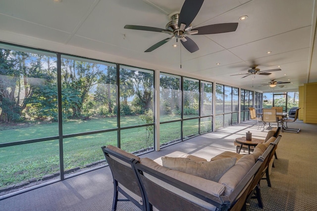 sunroom with plenty of natural light and ceiling fan