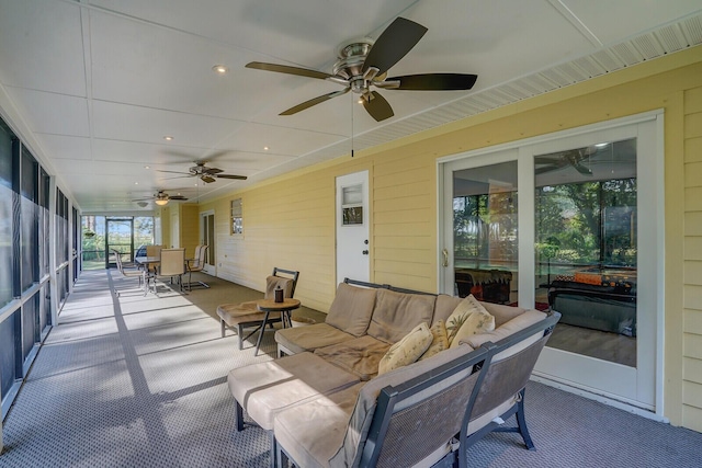 sunroom featuring ceiling fan