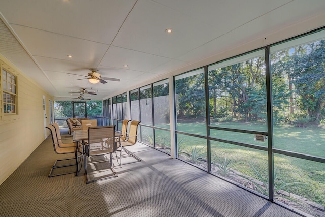 unfurnished sunroom with ceiling fan