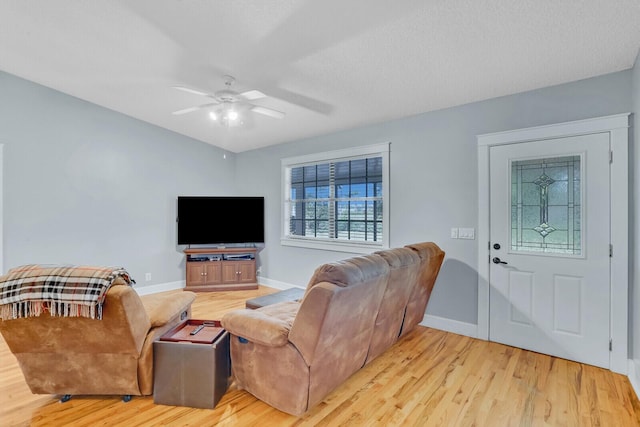 living room with ceiling fan and light wood-type flooring