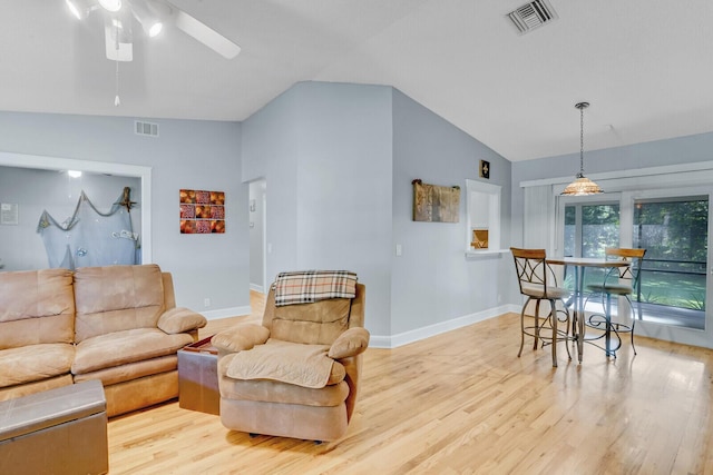 living room with ceiling fan, light hardwood / wood-style floors, and lofted ceiling