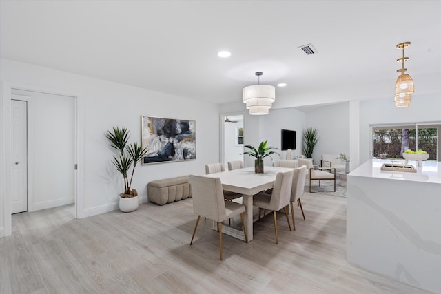 dining space with light wood-type flooring