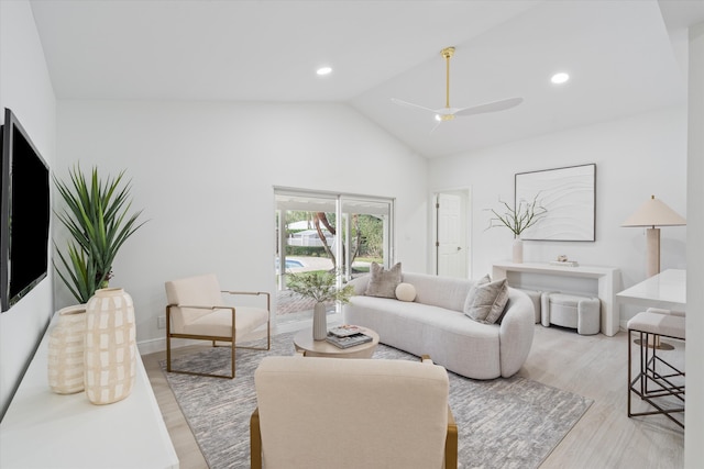 living room with ceiling fan, high vaulted ceiling, and light hardwood / wood-style flooring