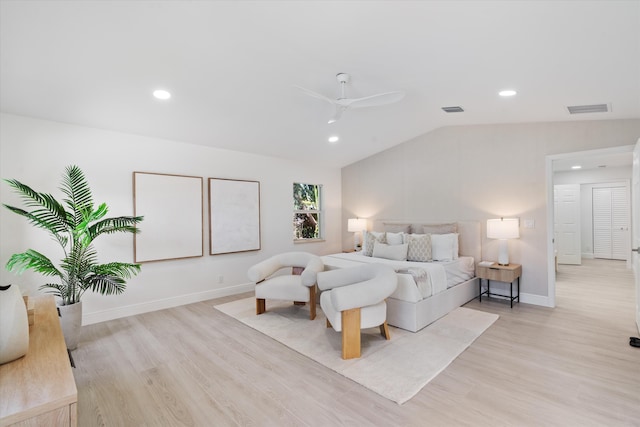 bedroom with ceiling fan, lofted ceiling, and light hardwood / wood-style flooring