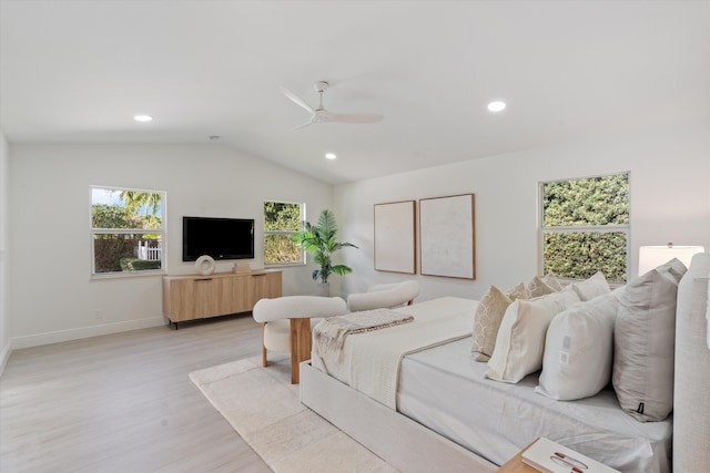 bedroom with multiple windows, ceiling fan, vaulted ceiling, and light wood-type flooring