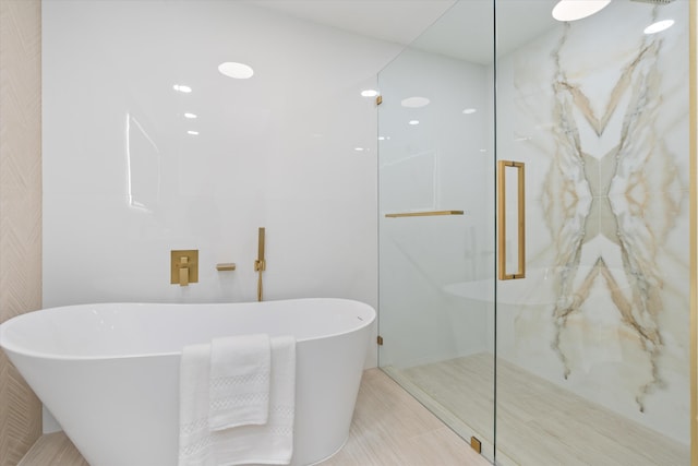 bathroom featuring shower with separate bathtub