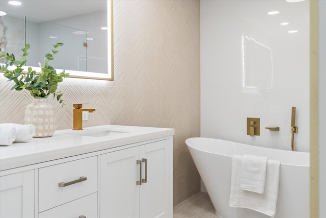 bathroom featuring a bathing tub and vanity