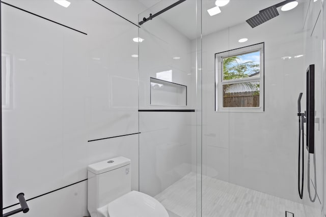 bathroom featuring toilet and walk in shower