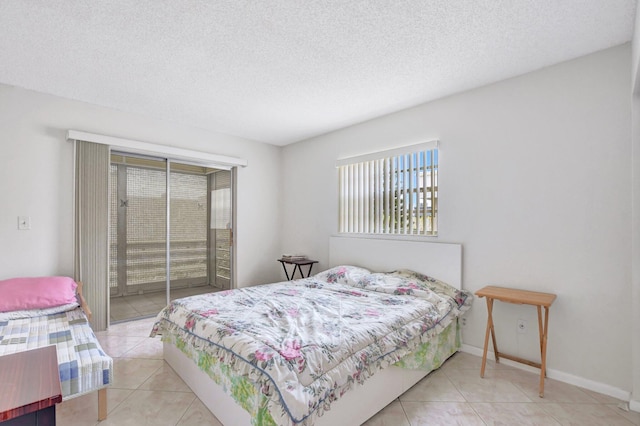 bedroom with light tile patterned floors and a textured ceiling