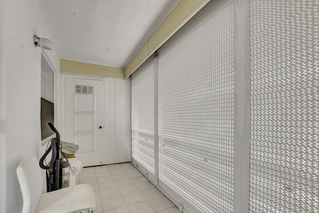 hall with light tile patterned flooring